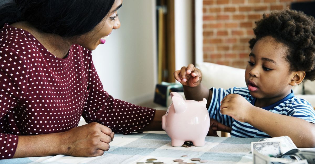 black mom and son with piggy bank